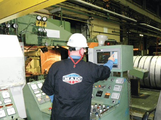Madi worker operating the machine